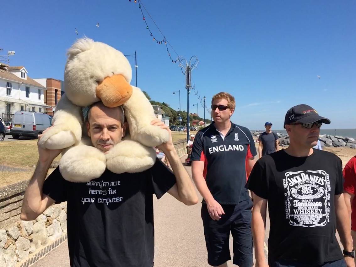 A group of people standing in front of a giant teddy bear

Description automatically generated
