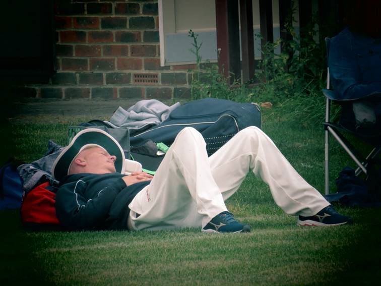 A person lying on the grass

Description automatically generated with medium confidence