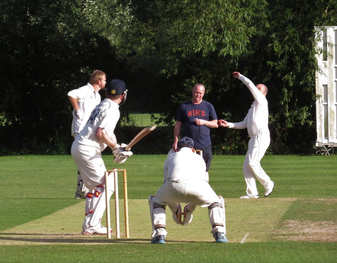 A group of men playing cricket

Description automatically generated