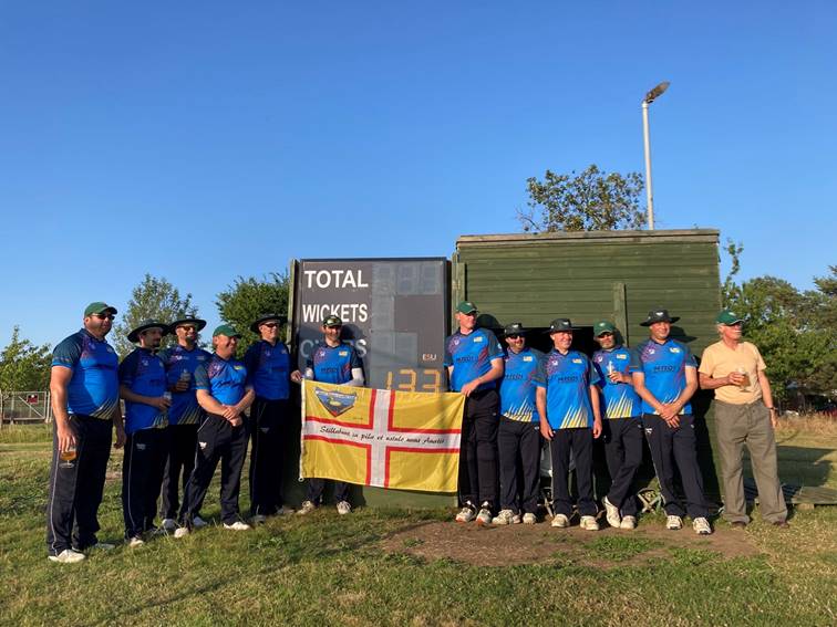 A group of people standing in front of a sign

Description automatically generated