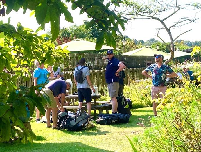 A group of people standing in a garden

Description automatically generated