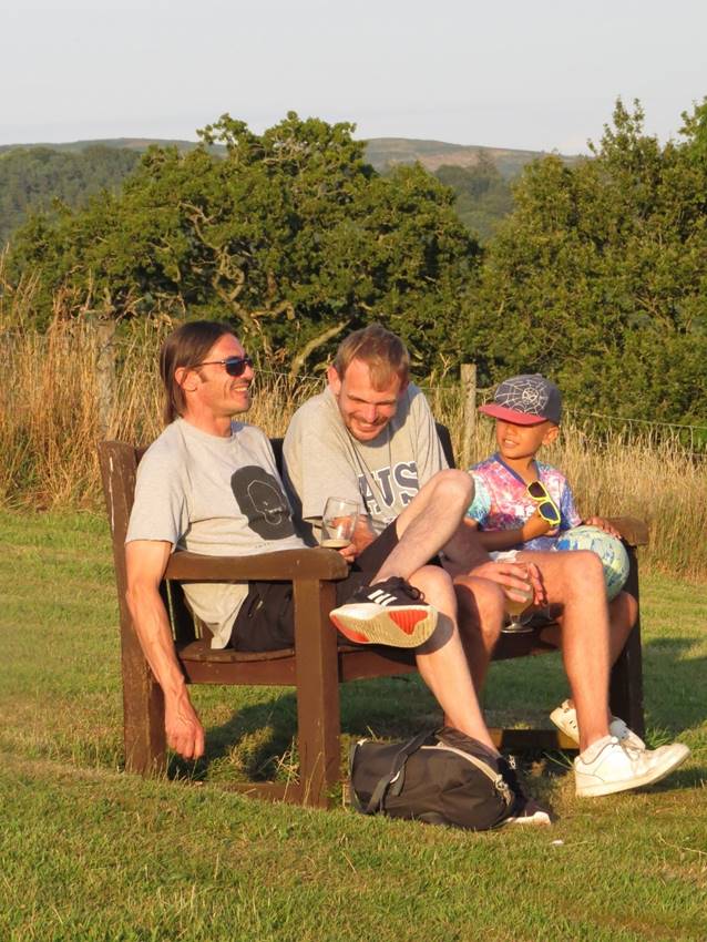 A group of people sitting on a bench

Description automatically generated