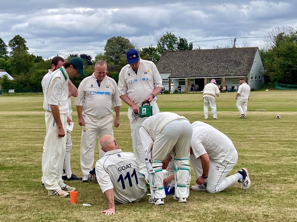 A group of men in white uniforms on a field

Description automatically generated