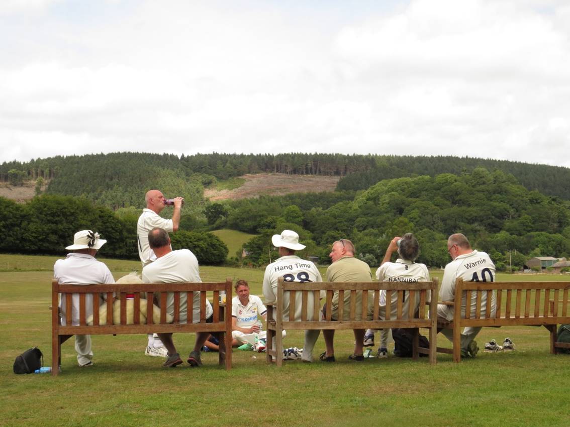 A group of people sitting on a bench

Description automatically generated