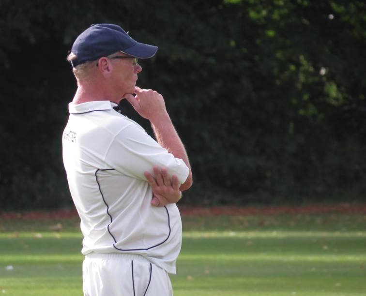 A person in a white shirt and blue hat

Description automatically generated