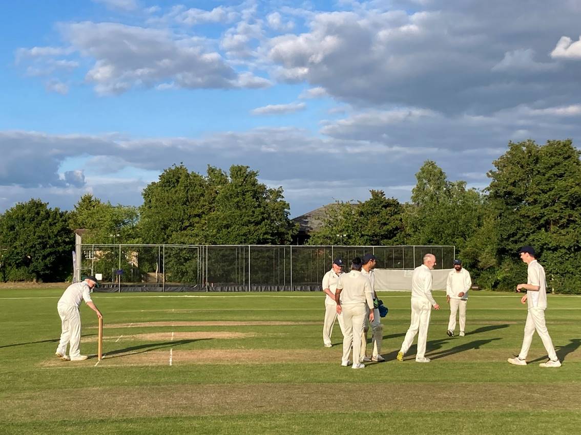 A group of people in white uniforms on a field

Description automatically generated