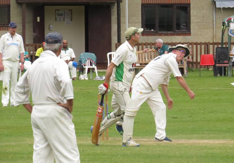 A group of men playing cricket

Description automatically generated