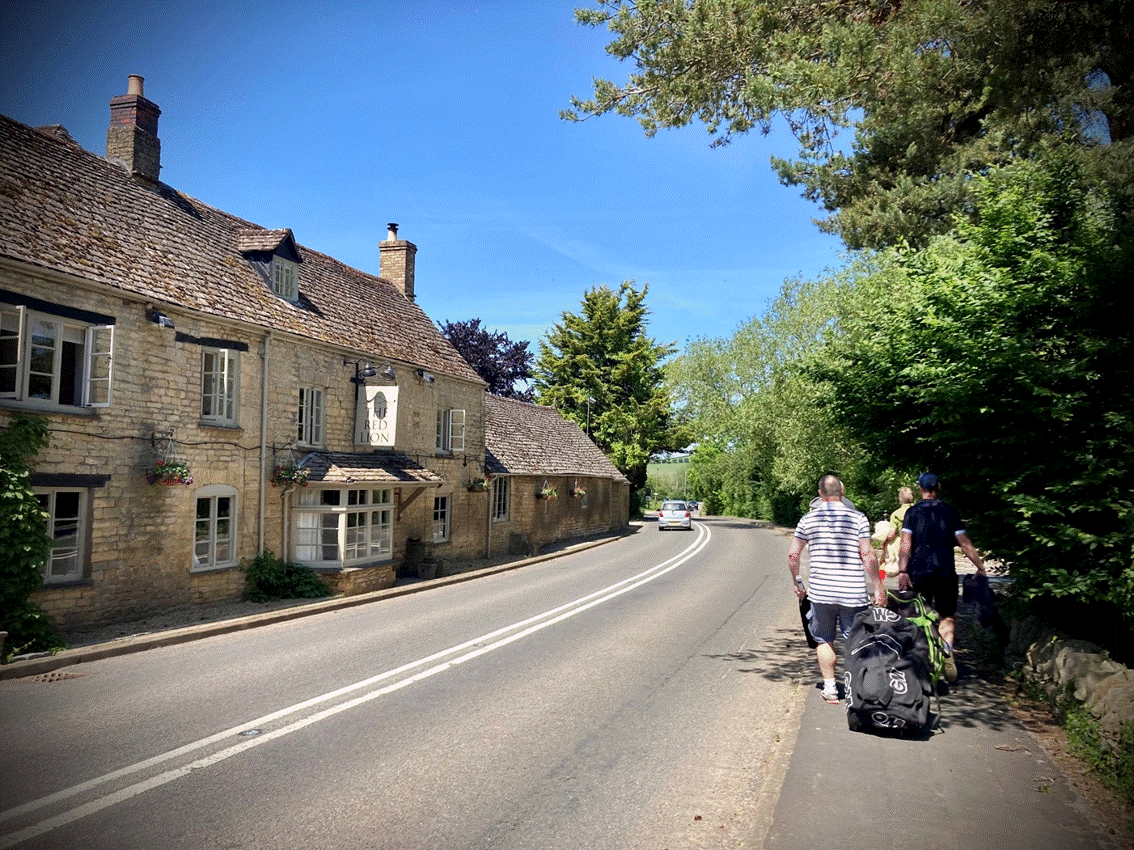 A group of people walking down a road

Description automatically generated