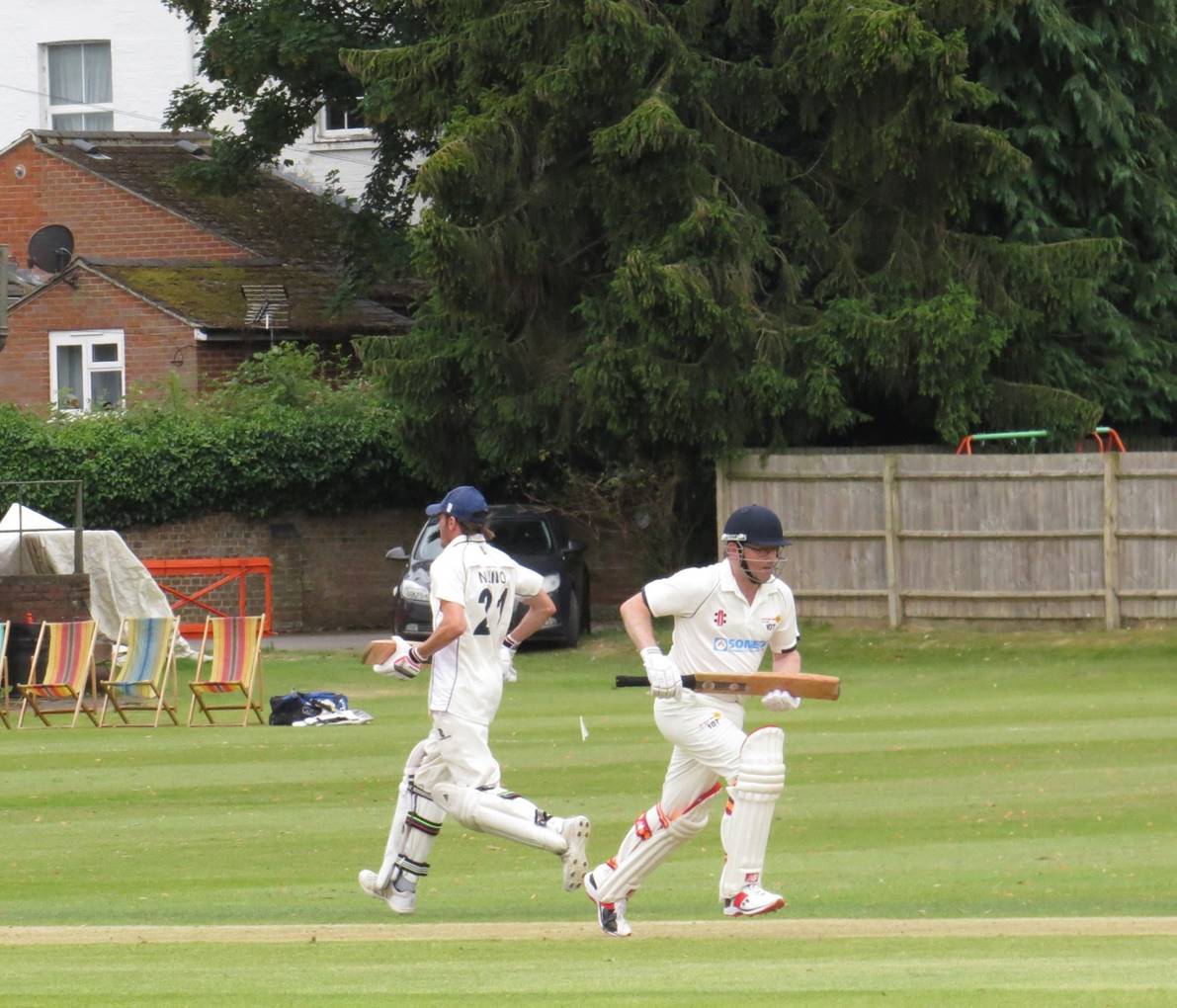 A group of men playing cricket

Description automatically generated