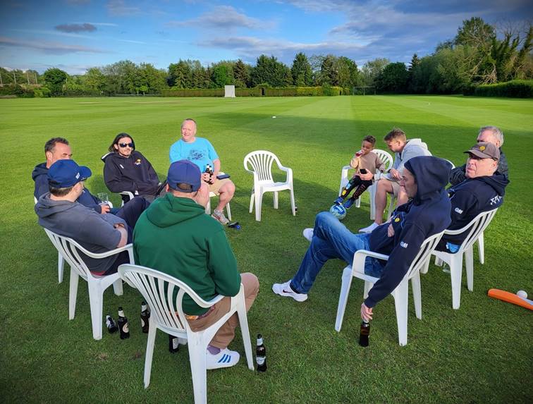 A group of people sitting in chairs on a grass field

Description automatically generated