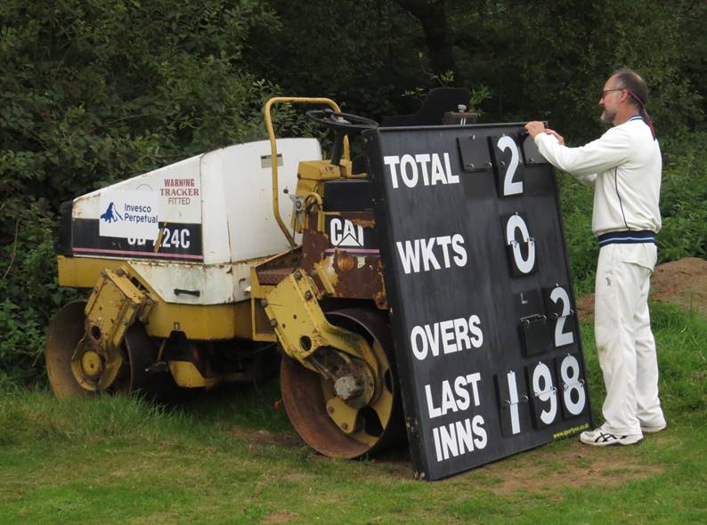 A person standing next to a large sign

Description automatically generated