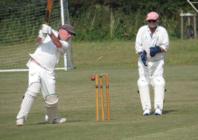 A group of men playing cricket

Description automatically generated