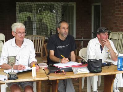 A group of men sitting at a table

Description automatically generated with medium confidence