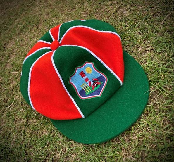 A green and red hat on grass

Description automatically generated