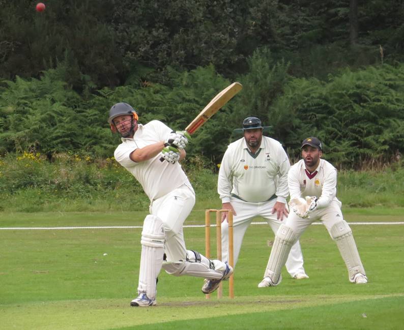 A group of men playing cricket

Description automatically generated