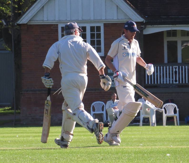 A group of men playing cricket

Description automatically generated