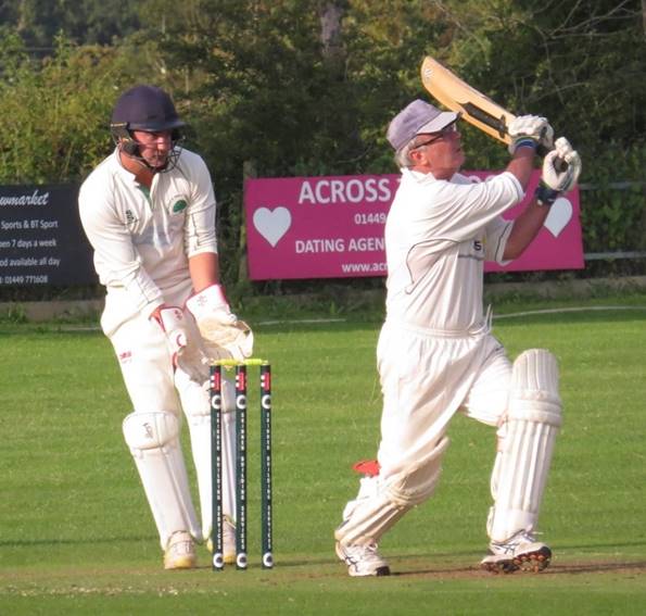 A group of men playing cricket

Description automatically generated