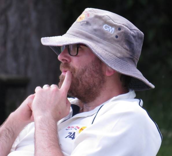 A person wearing a hat and smoking a cigarette

Description automatically generated with medium confidence